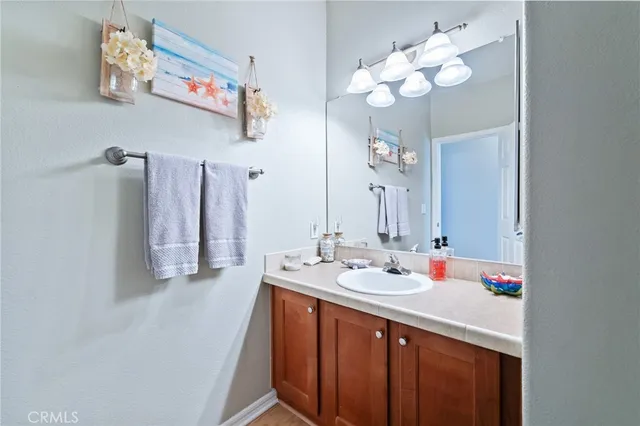 a bathroom with a sink vanity and a mirror