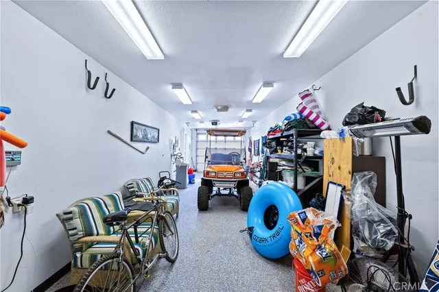 a view of a patio with dining table and chairs under an umbrella