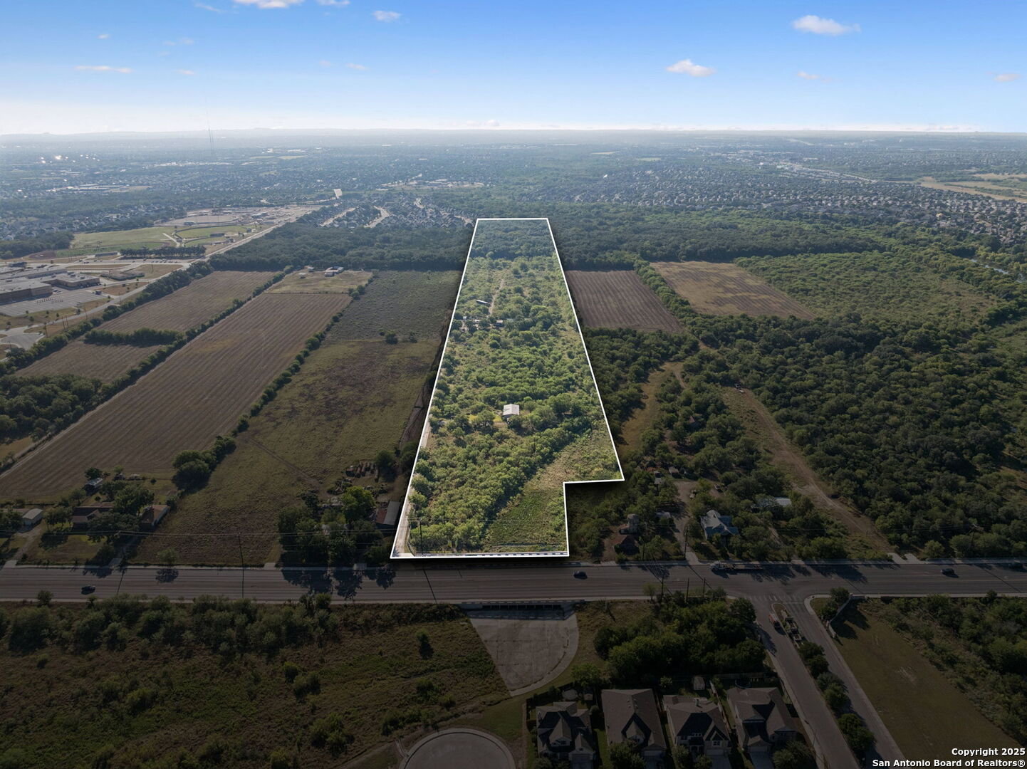 an aerial view of residential houses with outdoor space