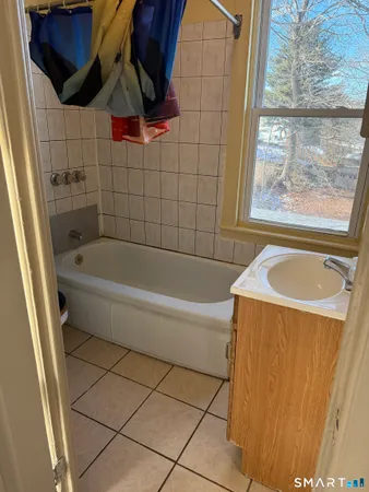 a bathroom with a bathtub and shower