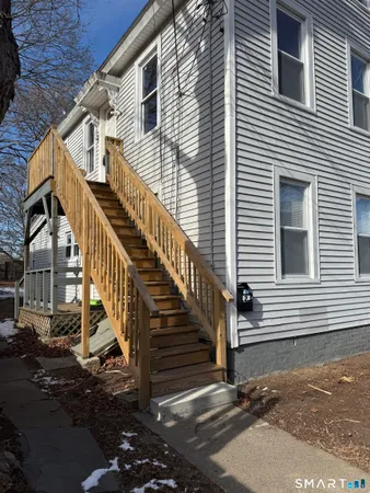 a view of a house with stairs and wooden floor