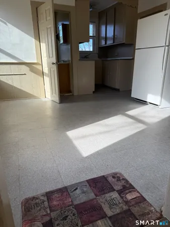 a kitchen with refrigerator and window