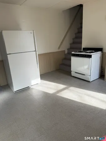 a kitchen with granite countertop white cabinets and a sink