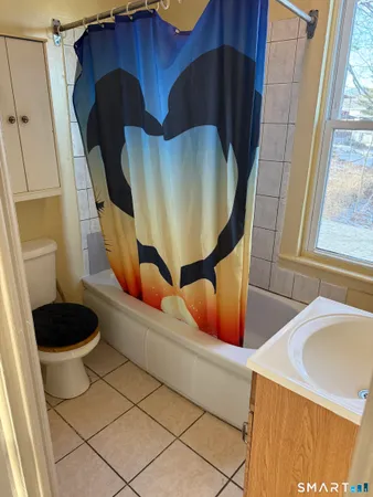 a view of a room with wooden floor and windows