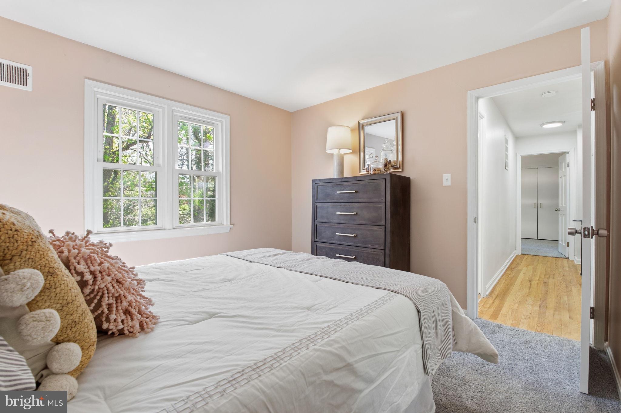 15101 Redgate Drive Silver Spring, MD 20905 - Photo 27 of 39 a bedroom with a bed and large windows