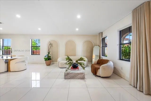 a large white kitchen with a large window
