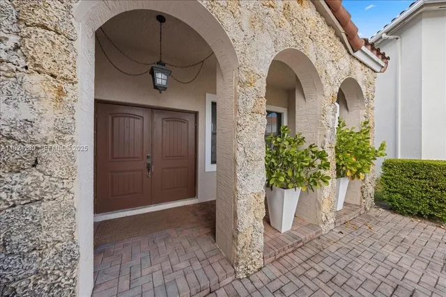 a front view of a house with a garden
