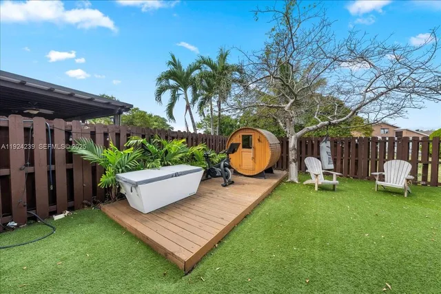 a front view of multiple houses with yard