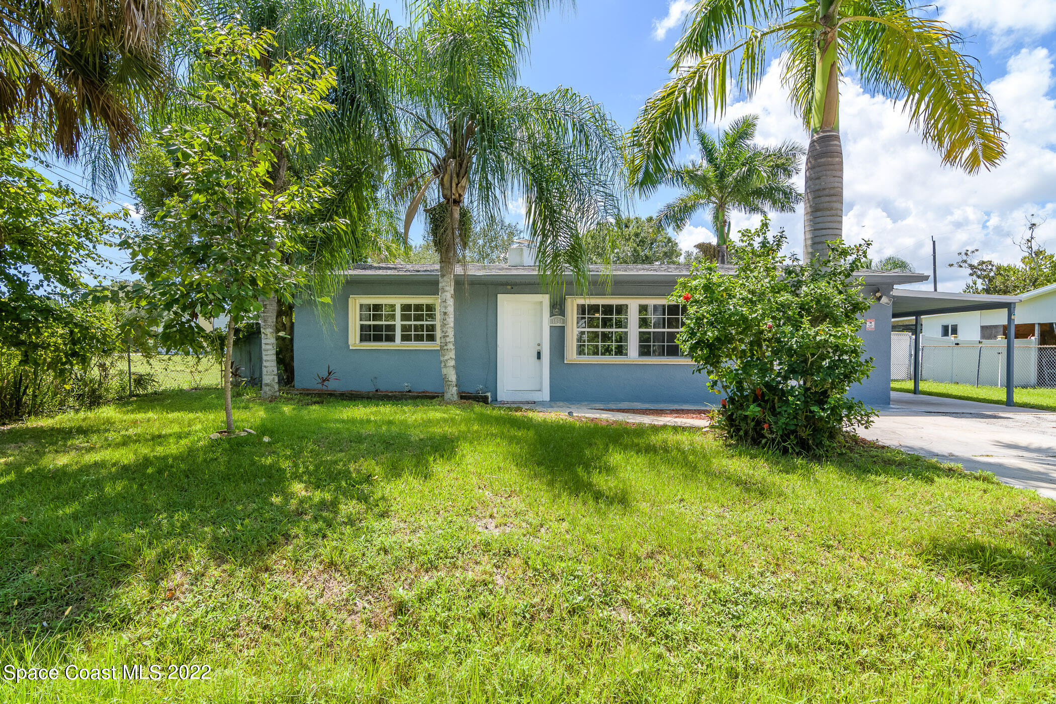 a view of house with a yard