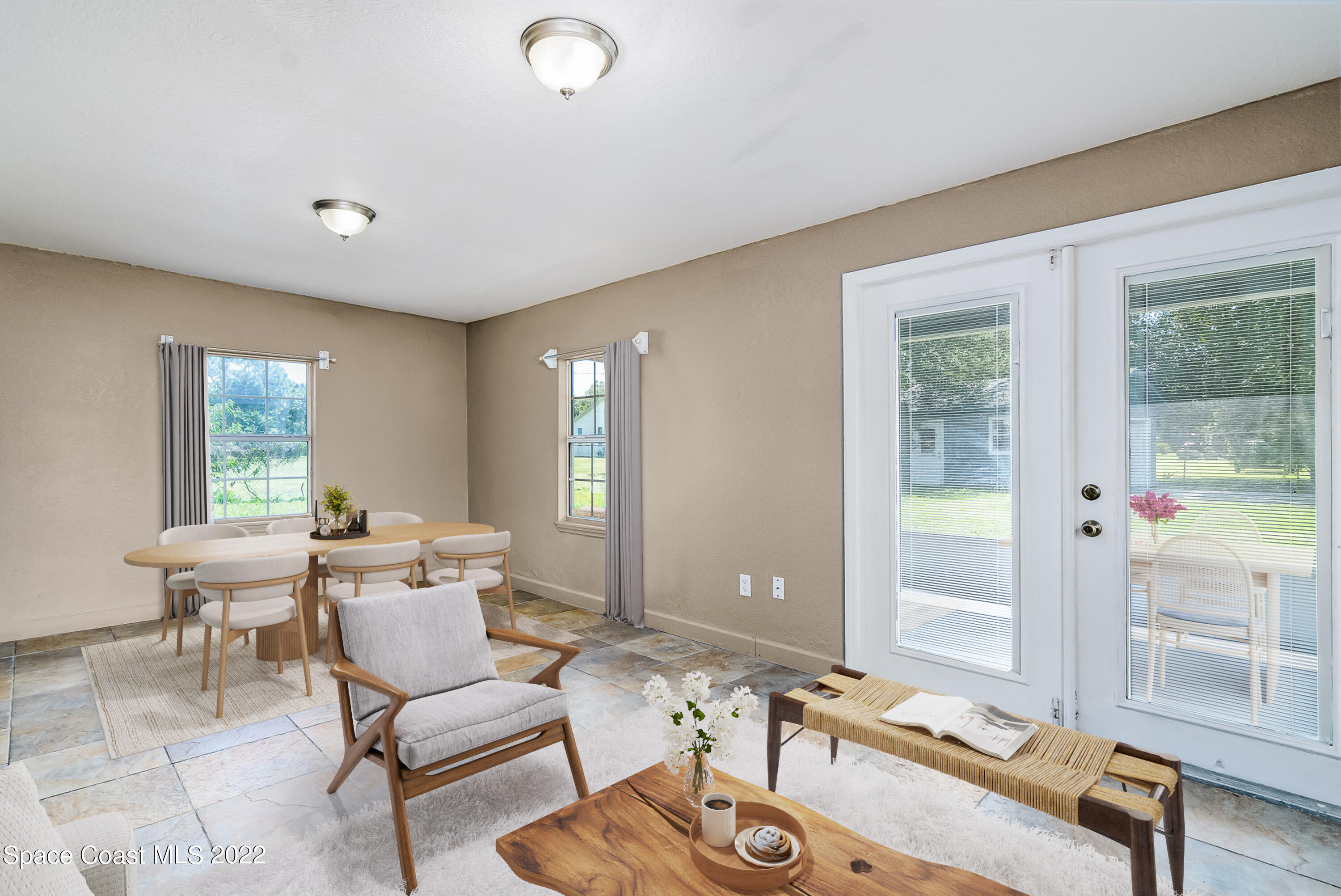1861 Trimble Road Melbourne, FL 32934 - Photo 18 of 46 a living room with furniture a table and a large window