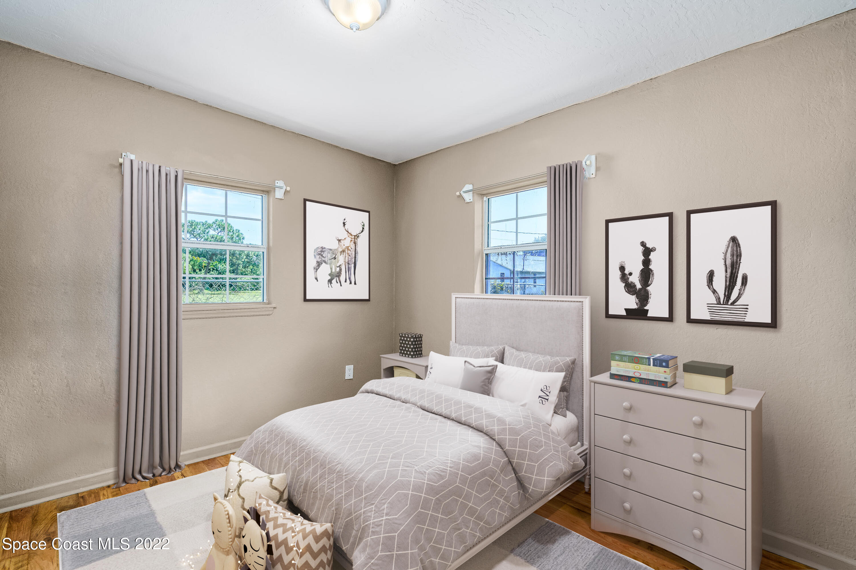 1861 Trimble Road Melbourne, FL 32934 - Photo 29 of 46 a bedroom with a bed and a window