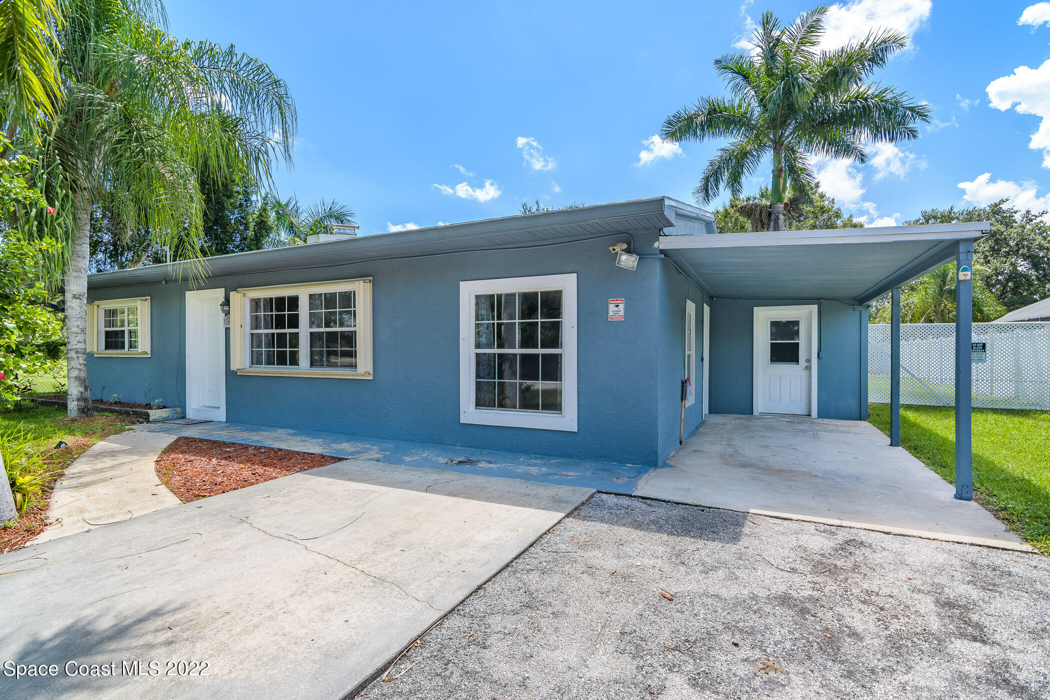 1861 Trimble Road Melbourne, FL 32934 - Photo 3 of 46 a front view of a house with a yard and potted plants