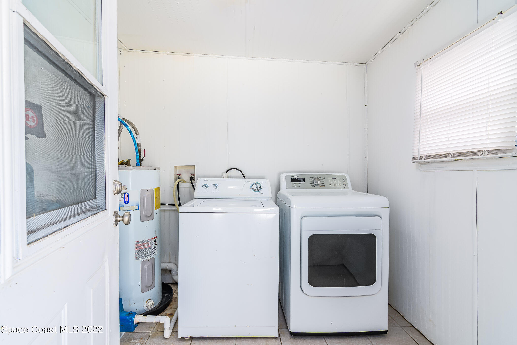 1861 Trimble Road Melbourne, FL 32934 - Photo 35 of 46 a utility room with dryer and washer