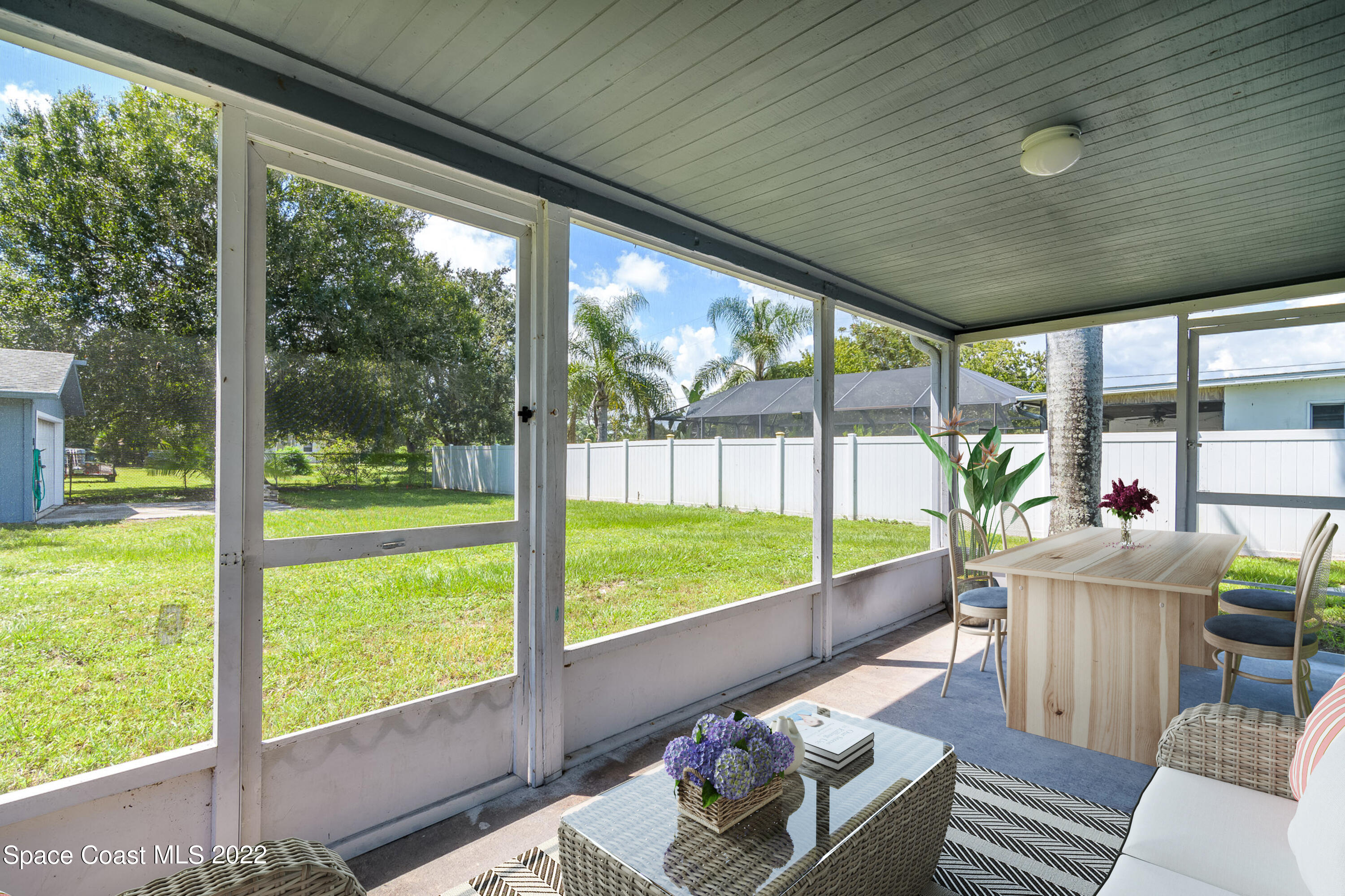1861 Trimble Road Melbourne, FL 32934 - Photo 37 of 46 a living room with couch and a floor to ceiling window