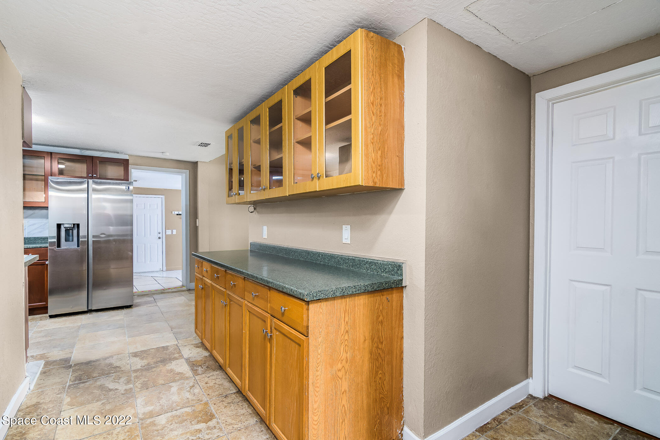 1861 Trimble Road Melbourne, FL 32934 - Photo 7 of 46 a kitchen with stainless steel appliances granite countertop a sink and cabinets