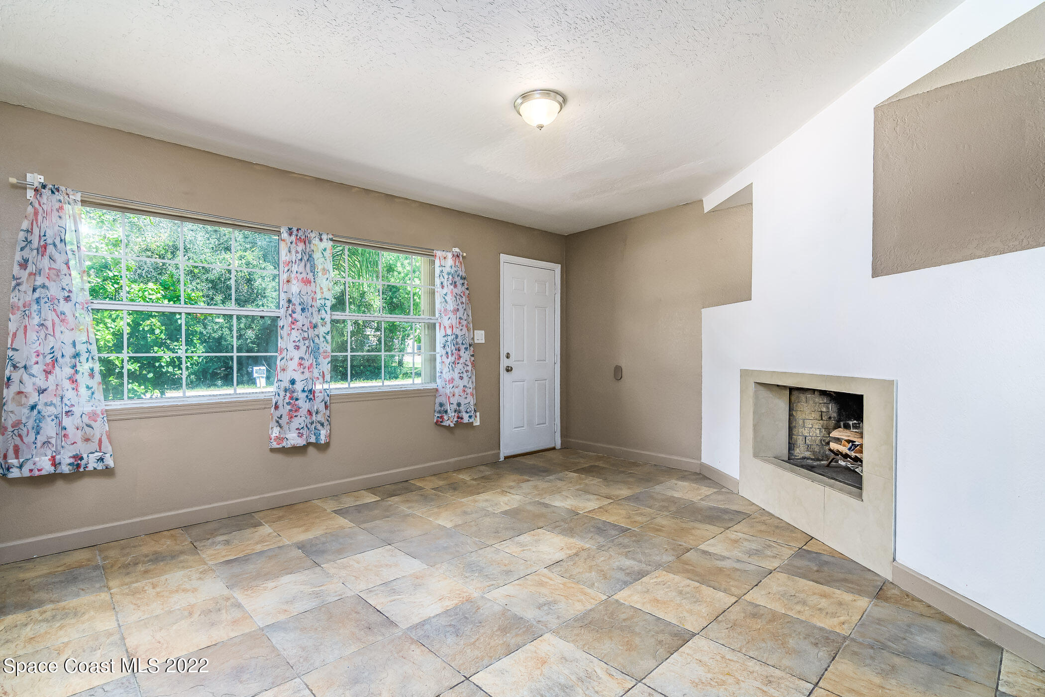 1861 Trimble Road Melbourne, FL 32934 - Photo 9 of 46 a view of an empty room with a window