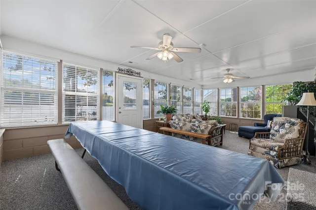 a view of a dining room with furniture a chandelier and wooden floor