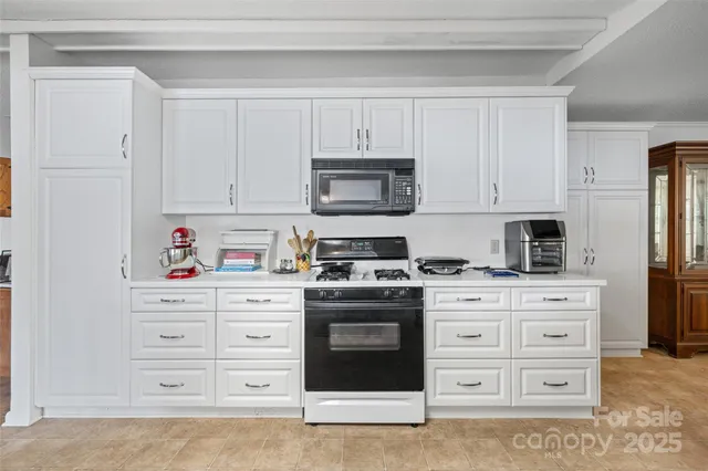 a kitchen with stainless steel appliances granite countertop a stove and a microwave