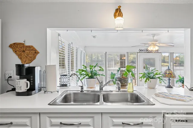 a kitchen counter with sink and window