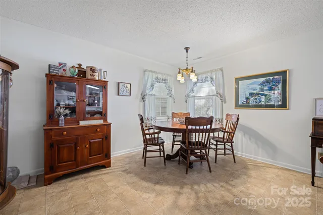 a view of a dining room with furniture and chandelier
