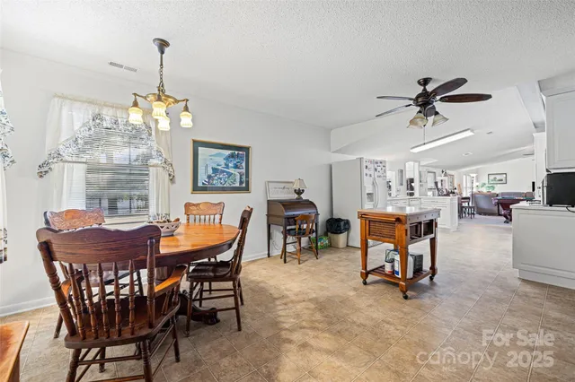 a dining room with furniture a chandelier and a rug