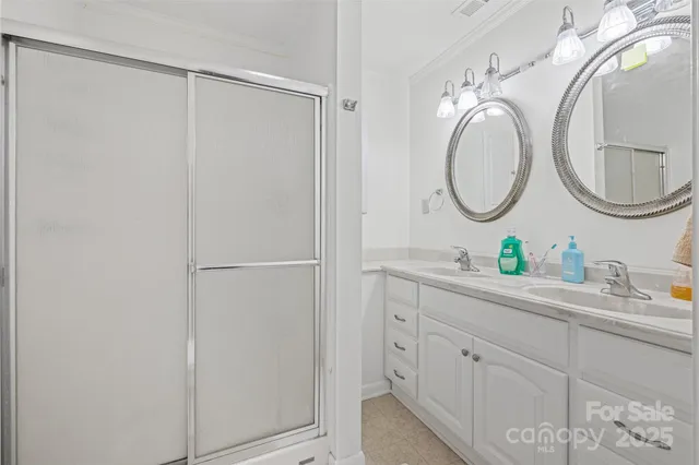 a bathroom with a double vanity sink and a mirror