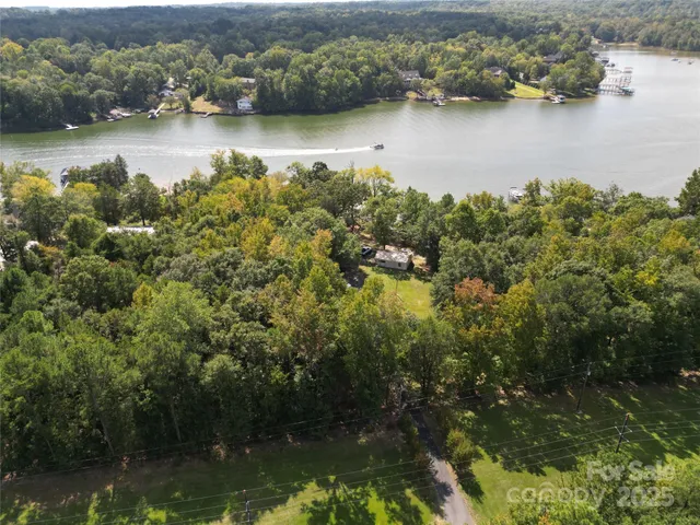 an aerial view of a houses with a lake view