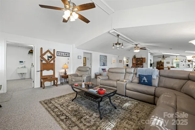 a living room with furniture a rug and a chandelier