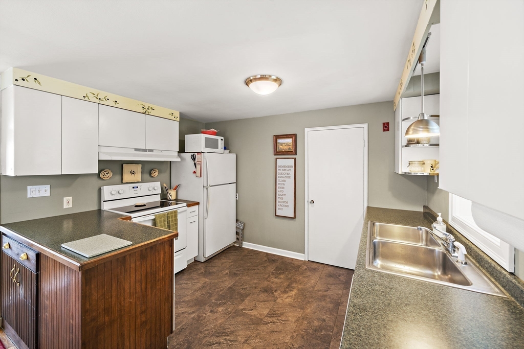 12 Dix Road Woburn, MA 01801 - Photo 12 of 33 a kitchen with granite countertop a refrigerator stove top oven and sink