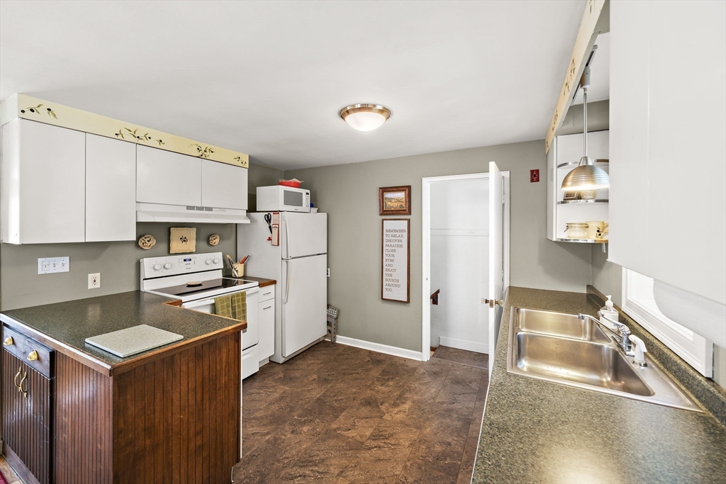 12 Dix Road Woburn, MA 01801 - Photo 13 of 33 a kitchen with granite countertop a refrigerator stove top oven and sink