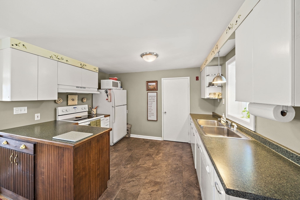 12 Dix Road Woburn, MA 01801 - Photo 14 of 33 a kitchen with granite countertop a sink stove and refrigerator