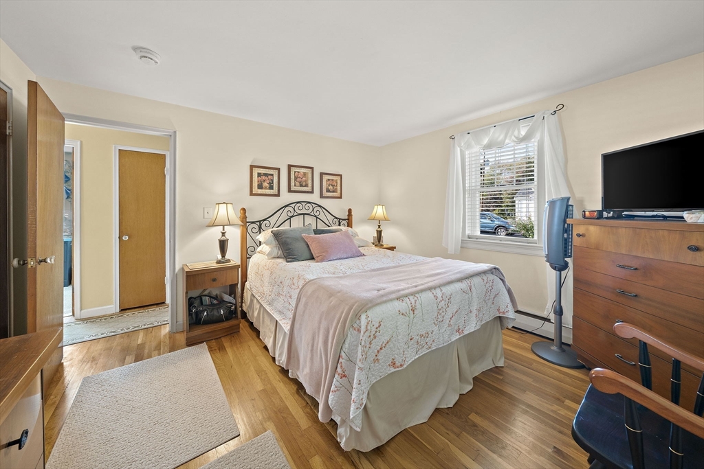 12 Dix Road Woburn, MA 01801 - Photo 15 of 33 a bedroom with a bed and a flat screen television