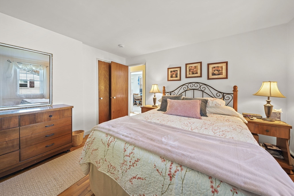 12 Dix Road Woburn, MA 01801 - Photo 16 of 33 a bedroom with a bed and wooden floor