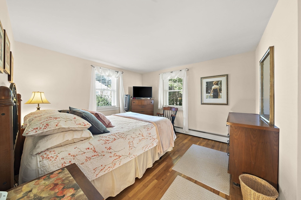 12 Dix Road Woburn, MA 01801 - Photo 17 of 33 a bedroom with a bed and wooden floor