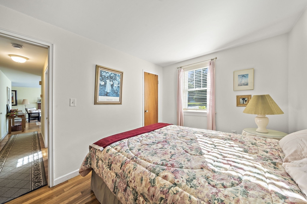 12 Dix Road Woburn, MA 01801 - Photo 18 of 33 a bedroom with a bed and wooden floor