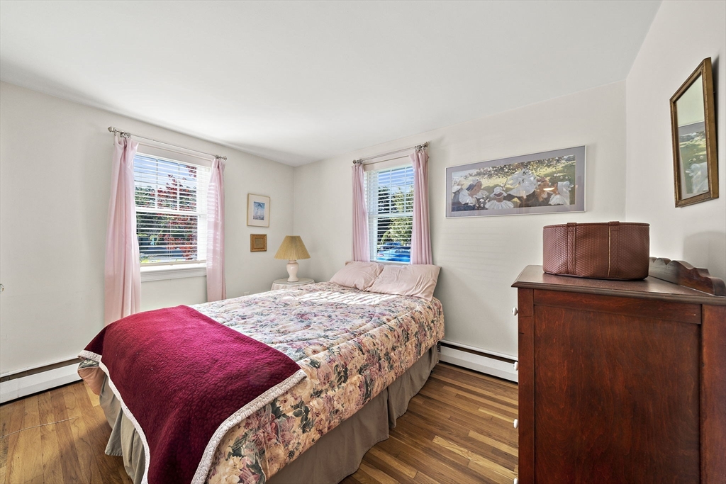 12 Dix Road Woburn, MA 01801 - Photo 19 of 33 a bedroom with a bed and a dresser next to a window