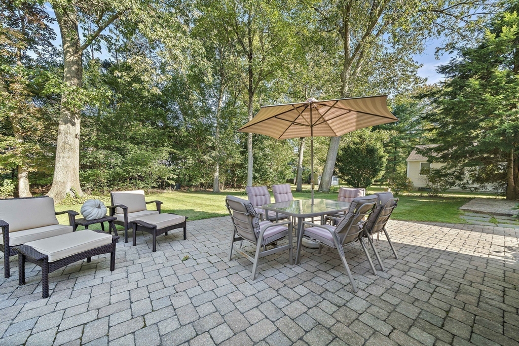 12 Dix Road Woburn, MA 01801 - Photo 30 of 33 a view of a patio with table and chairs under an umbrella