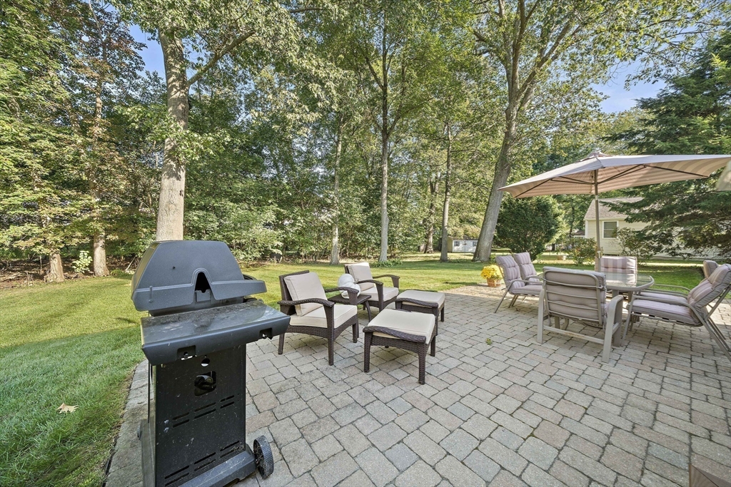 12 Dix Road Woburn, MA 01801 - Photo 31 of 33 a view of a patio with table and chairs under an umbrella