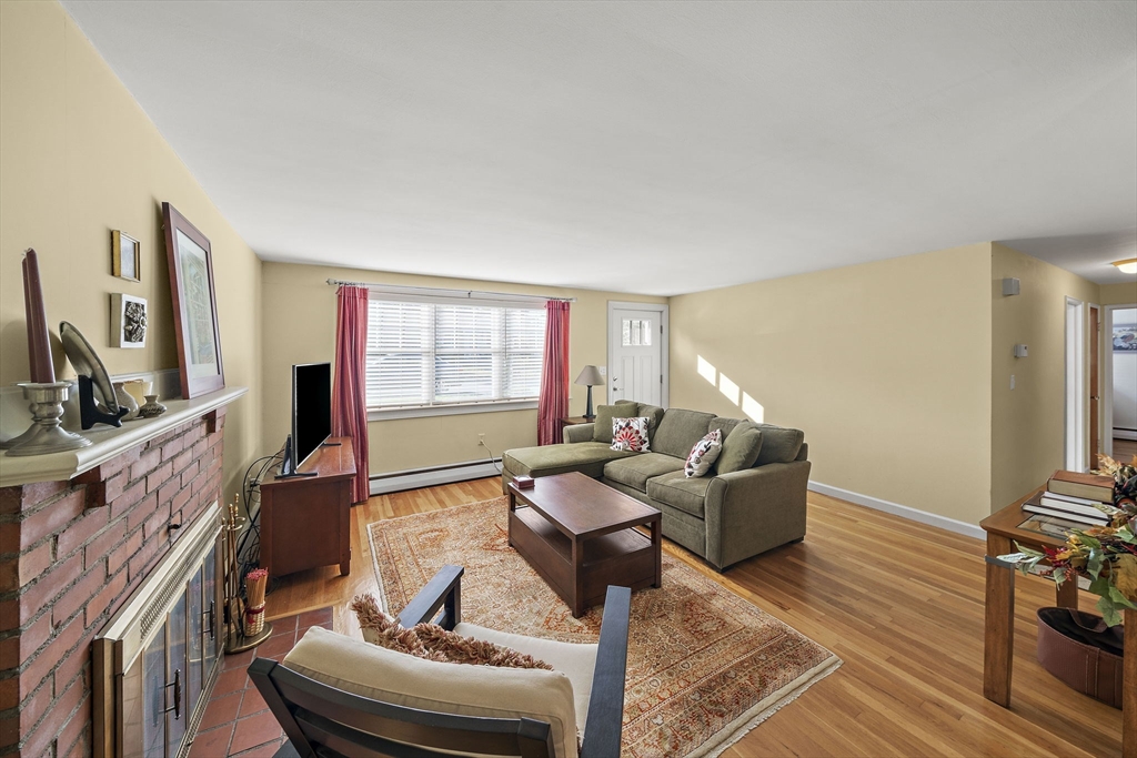 12 Dix Road Woburn, MA 01801 - Photo 5 of 33 a living room with furniture and a flat screen tv