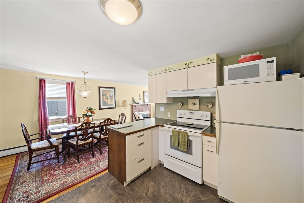 12 Dix Road Woburn, MA 01801 - Photo 10 of 33 a kitchen with a sink a stove and white cabinets