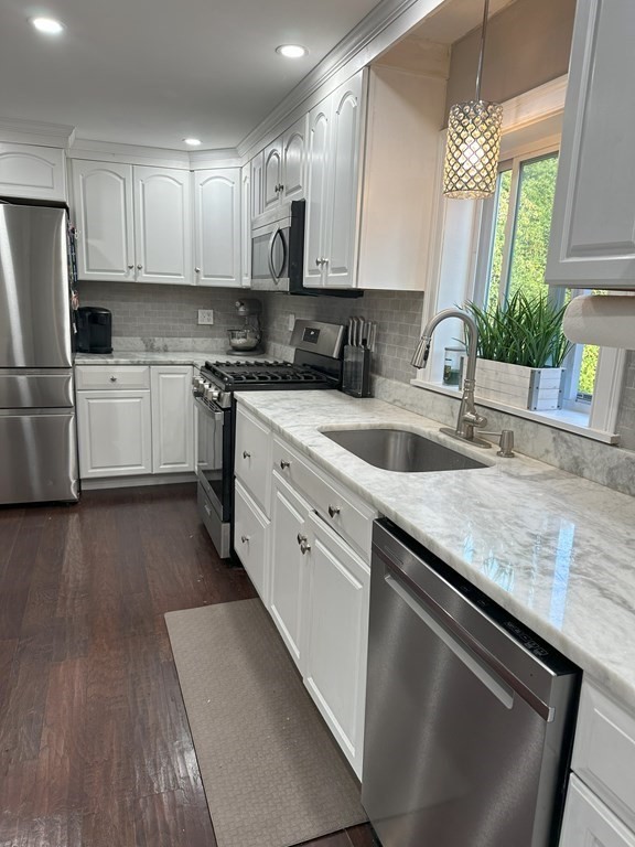 129 Conant Street Danvers, MA 01923 - Photo 2 of 14 a kitchen with stainless steel appliances granite countertop a sink a stove and a refrigerator