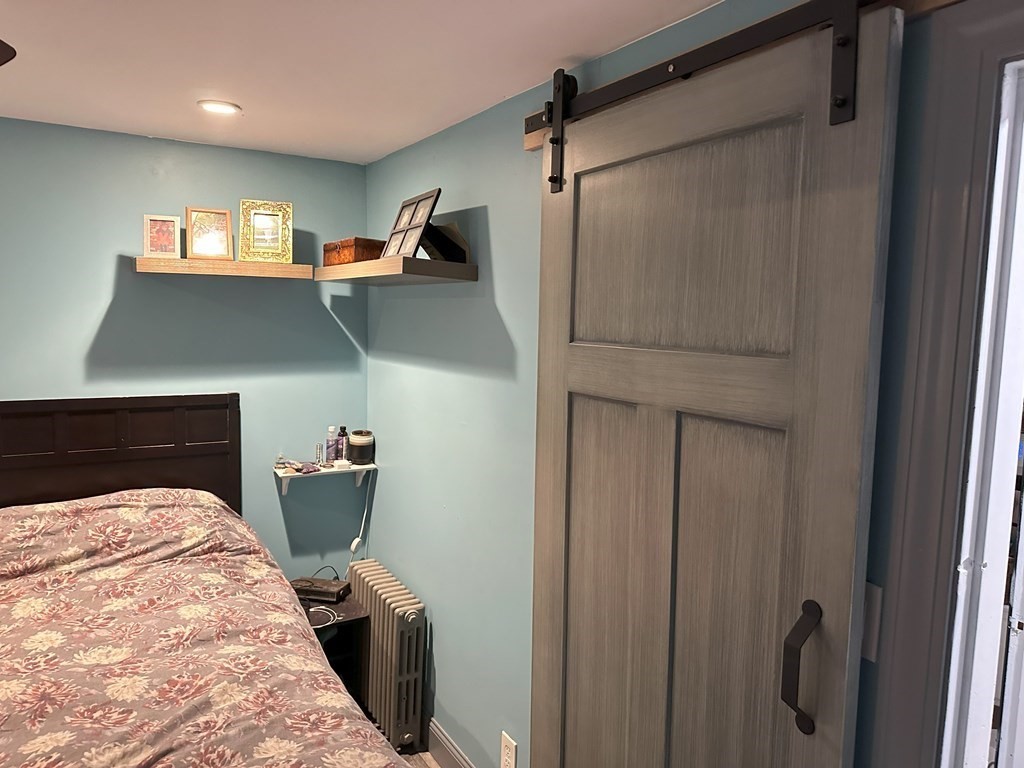 129 Conant Street Danvers, MA 01923 - Photo 4 of 14 a bedroom with a bed and a television