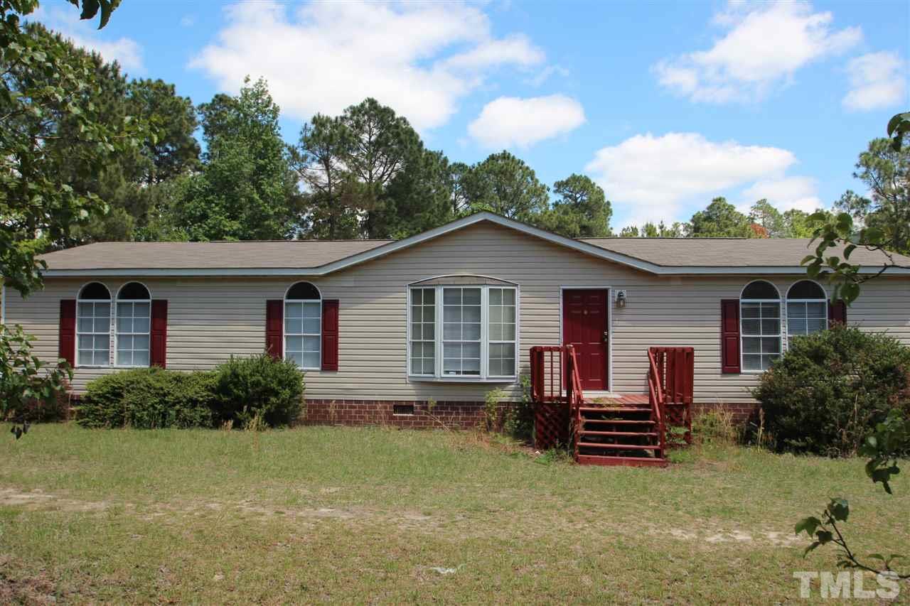 407 Line Road Cameron, NC 28326 - Photo 1 of 13 a view of front of a house with a yard