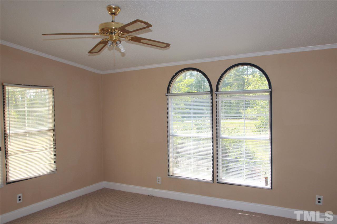 407 Line Road Cameron, NC 28326 - Photo 11 of 13 an empty room with ceiling fan and windows
