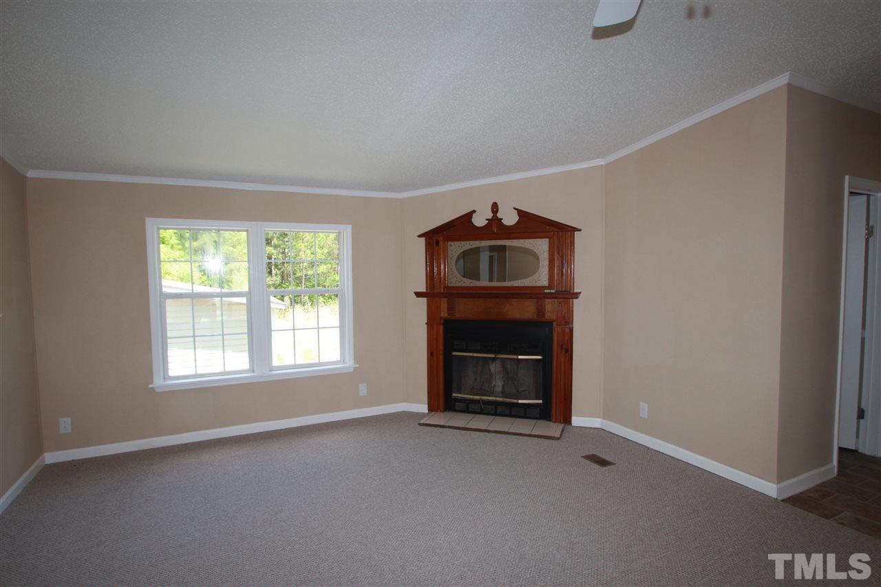 407 Line Road Cameron, NC 28326 - Photo 3 of 13 a view of empty room with a fireplace