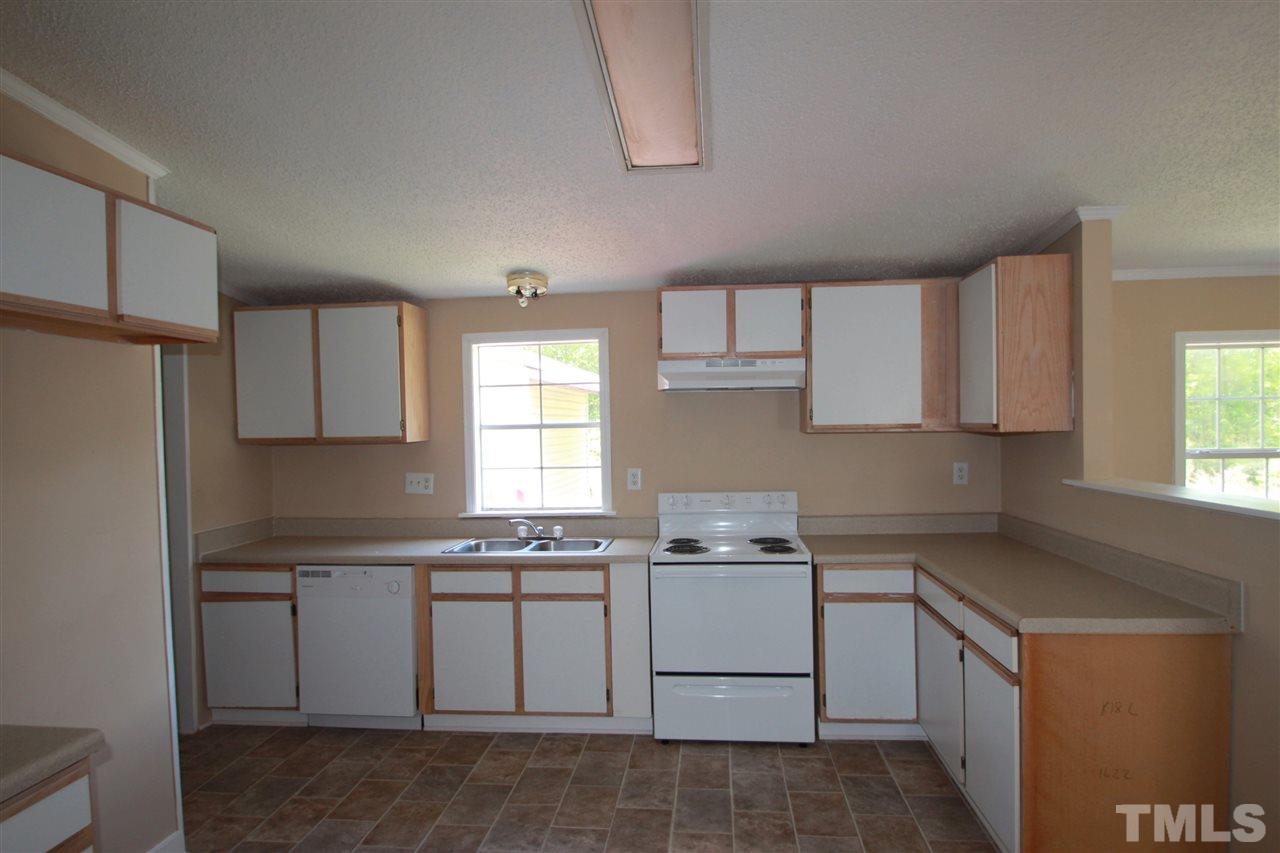 407 Line Road Cameron, NC 28326 - Photo 5 of 13 a kitchen with cabinets appliances a sink and a window