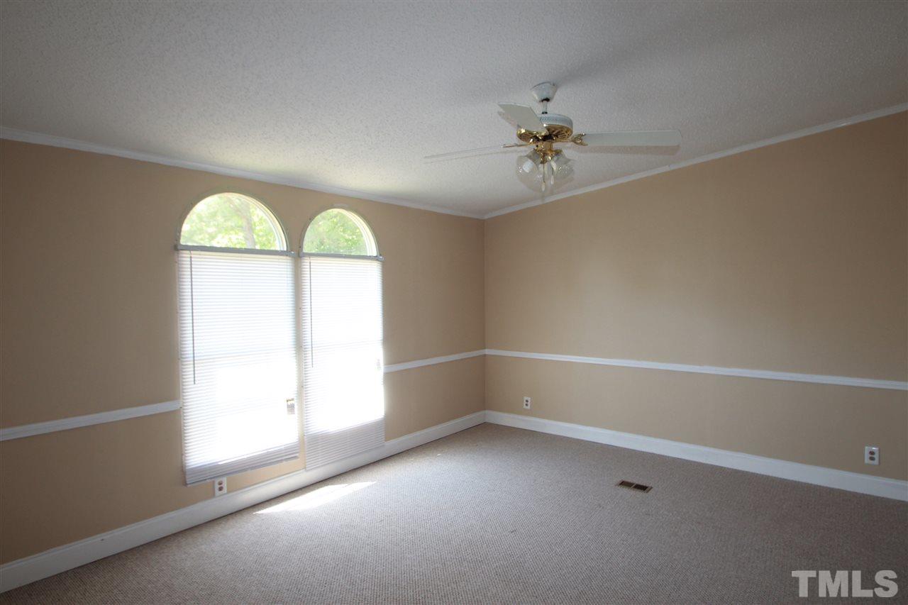 407 Line Road Cameron, NC 28326 - Photo 7 of 13 an empty room with a window and a ceiling fan