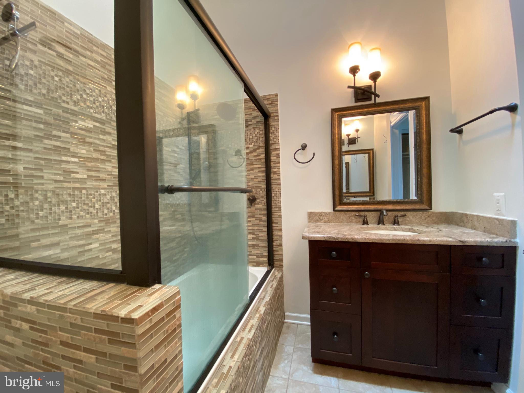 12944 Grays Pointe Road, Unit 12944C Fairfax, VA 22033 - Photo 11 of 16 a bathroom with a sink a vanity and a mirror