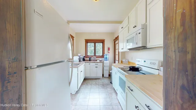 a kitchen with a cabinets and white appliances