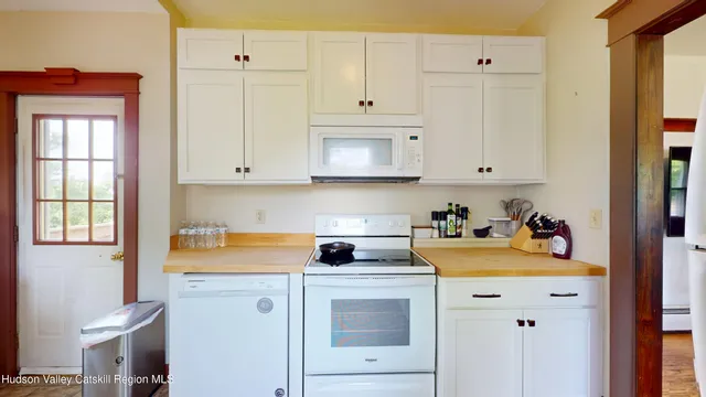 a view of a kitchen with stove and cabinets
